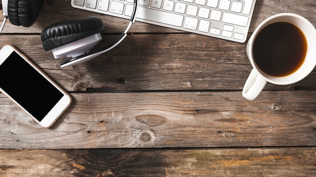 Overhead View of Cellphone, Headphone, and Keyboard with Coffee Cup – Free Download