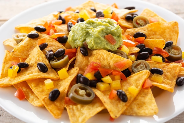 Delicious Mexican Nachos with Black Beans, Guacamole, Tomato, and Jalapeno – Free to Download