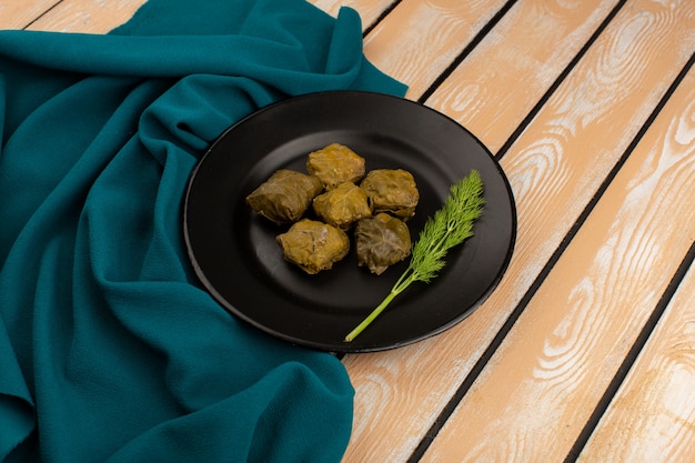 Dolma on a Black Plate: Tasty Green Dish on Wooden Floor – Free Stock Photo, Download for Free