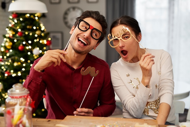 Playful Couple in Christmas Masks – Free Stock Photo Download