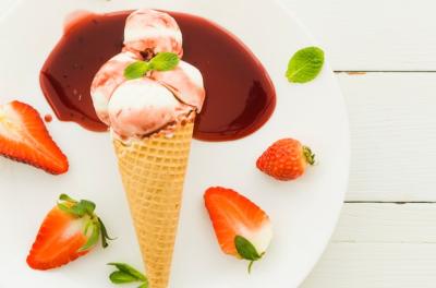 Delicious Ice Cream in Waffle Cone with Strawberry Syrup – Free Download