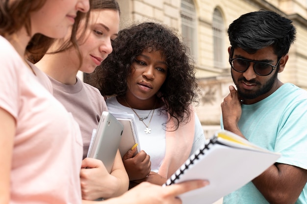 Colleagues Studying Together in Front of Their College – Free Download