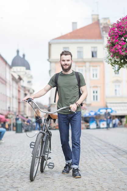 Young Man Walking with Bicycle on the Street – Free Stock Photo for Download