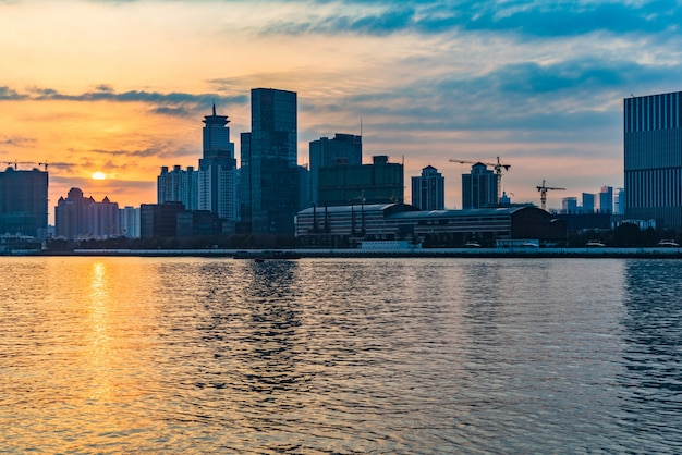 City Skyline by River Under a Cloudy Sky – Free Stock Photo for Download