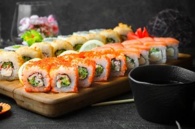 Side View of Sushi Set with Soy Sauce and Chopsticks on Wooden Serving Board – Free Download