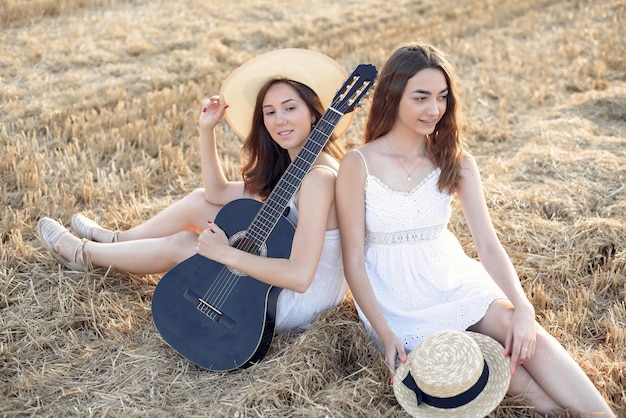 Beautiful Elegant Girls in an Autumn Wheat Field – Download Free Stock Photo