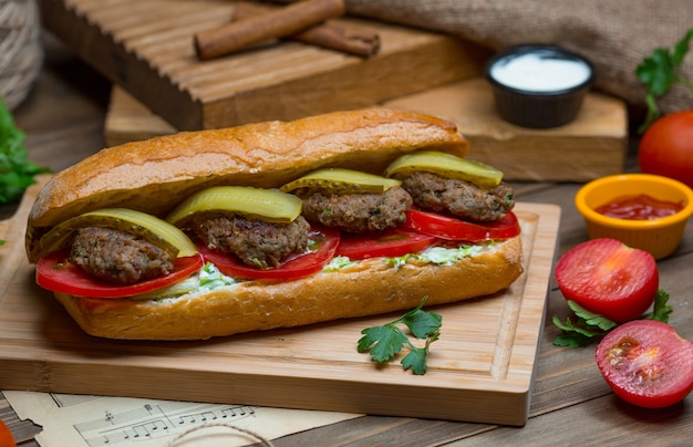 A Delicious Meatball-Stuffed Bread Bun with Fresh Ingredients – Free Download