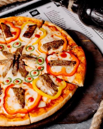 Delicious Pizza Topped with Meat, Bell Peppers, and Chili Peppers – Free Stock Photo for Download