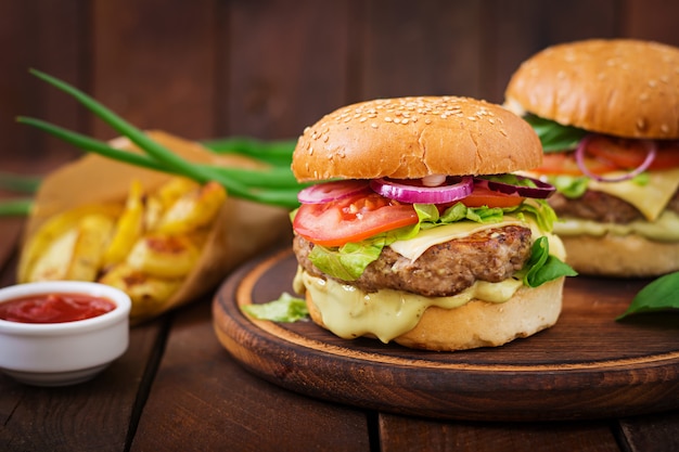 Juicy Beef Hamburger with Cheese, Tomato, and Red Onion on Wooden Table – Free Download