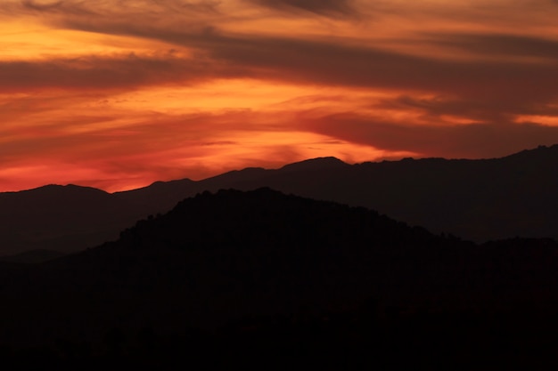 Dark Yellow Clouded Sky with Black Mountains – Free Stock Photo, Download Free