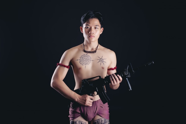 Young Thailand Male Warrior in Fighting Stance with Firearm – Free Download