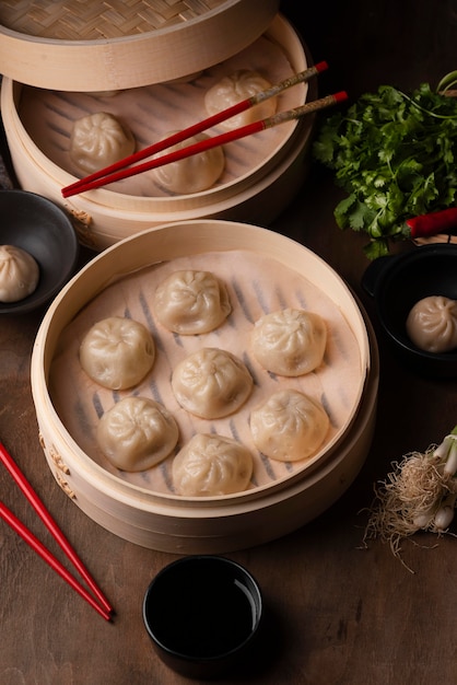 High Angle View of Asian Dumplings with Chopsticks and Fresh Herbs – Free Download