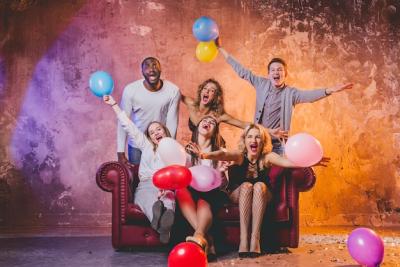 Happy Friends Enjoying Balloons on a Couch – Free Stock Photo for Download