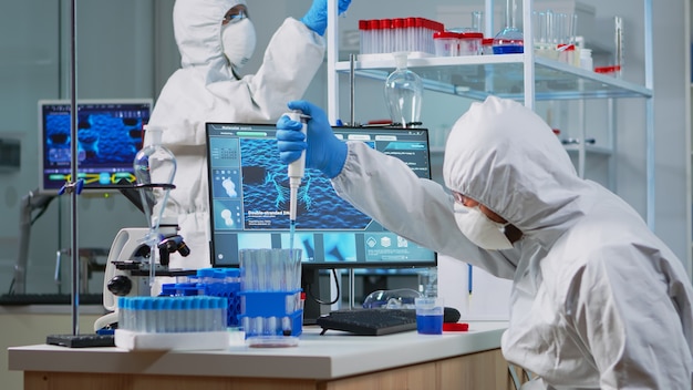 Research Scientist in Protective Suit Conducting Lab Tests on Virus Evolution – Free Stock Photo for Download