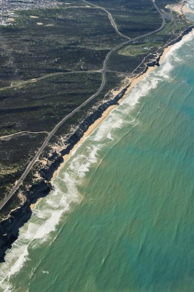 Aerial Vertical Shot of a Road Surrounded by Grassy Fields Near a Beach Shore – Free Stock Photo, Download for Free