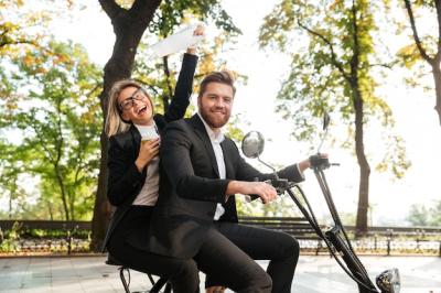 Elegant Couple Laughing on a Modern Motorbike – Free Download