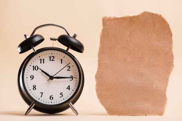 Blank Brown Torn Paper and Black Alarm Clock on Colorful Background – Free Stock Photo for Download