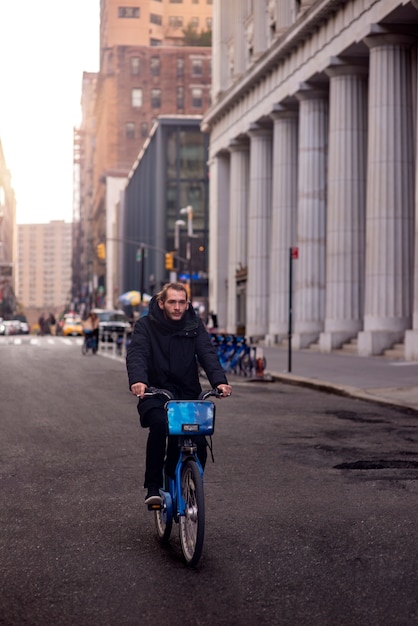 Young Adult Riding a Bicycle in the City | Free Download