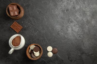 Top View of Chocolate and Chocolate Cream in Wooden Bowls on a Black Table – Free Download