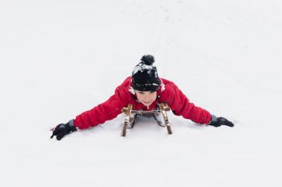 Happy Boy Sledging on Snowy Landscape – Free to Download