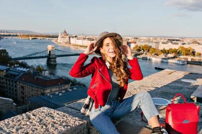 Fascinating Young Woman Laughing with Hat in City Background – Free Download