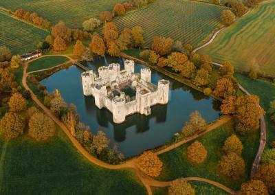 Aerial View of a Stunning Old Castle on a Serene Lake for Free Download