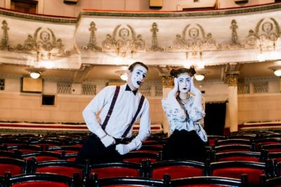 Male Mime Posing Next to Sad Female Mime on Chair – Free Download