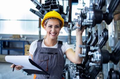 Female Industrial Employee in Working Uniform and Hardhat on Factory Production Line – Free Download