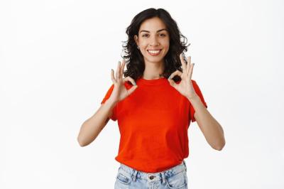 Smiling Woman Giving a Compliment with OK Gesture on White Background – Free Download