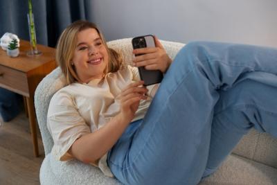 High Angle Shot of a Woman Engaged in Video Calls with Smartphone – Free Download