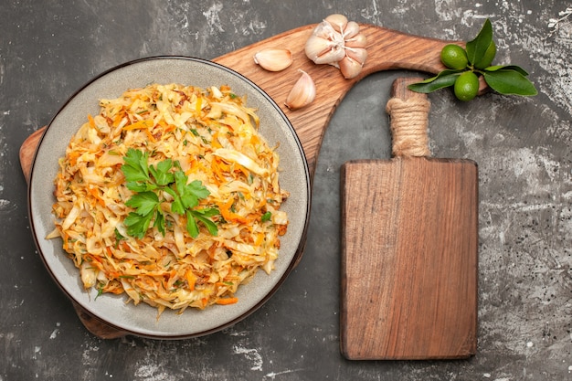 Close-Up of Cabbage Dish with Garlic and Citrus on Wooden Board – Free Download