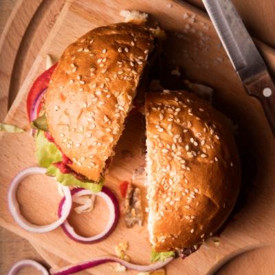 Top View of a Halved Hamburger on a Wooden Board – Free Stock Photo, Download for Free