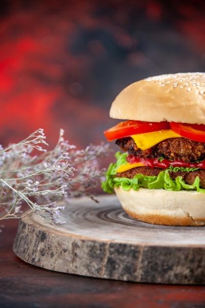 Meat Burger with Cheese, Tomatoes, and Salad on a Dark Background – Free Download