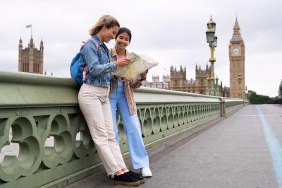 Smiley Women Looking at Map – Free Stock Photo for Download