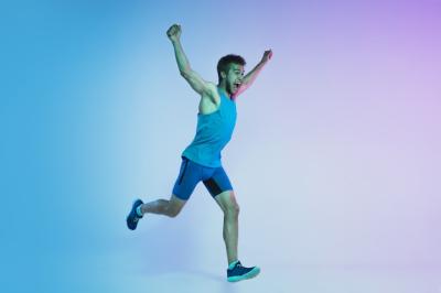 Active Young Caucasian Man Jogging in Neon Light – Free Download