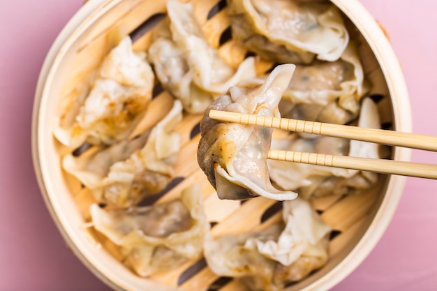 Close-up of Dumpling in Chopsticks – Free Stock Photo for Download