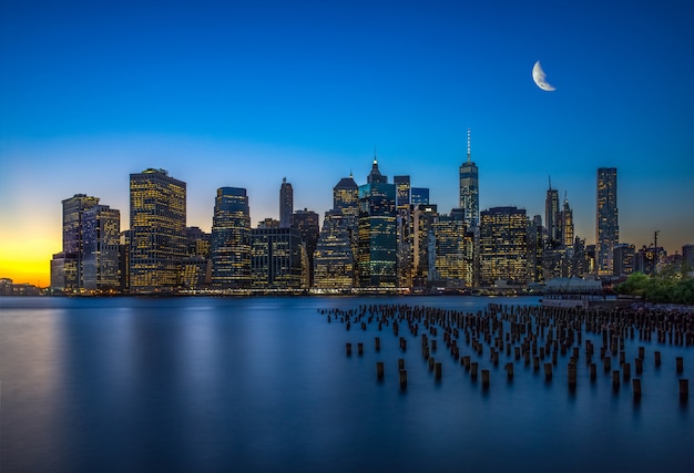 Evening Reflections of Manhattan Skyscrapers over Water – Free Download