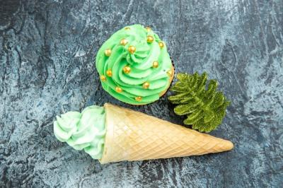 Ice Cream Christmas Tree Cupcake and Golden Christmas Tree Toy on Grey Surface – Free Download