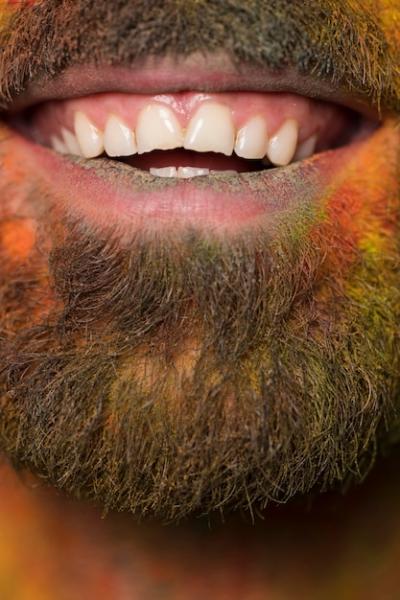 Mouth of Toothy Smiling Bearded Man with Rainbow Paint on Face – Free Download