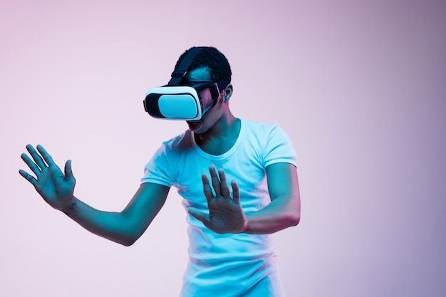 Young Man Enjoying VR Glasses in Neon Light – Free Stock Photo for Download