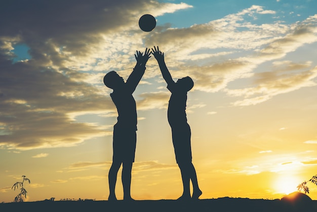 Silhouette of Children Playing Soccer Football – Free Download