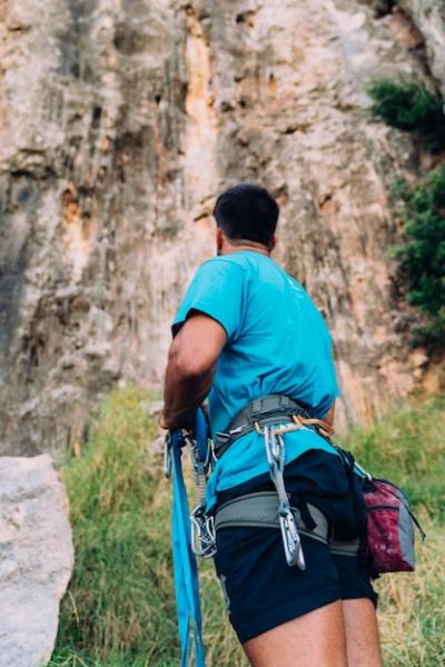 Climber Gazing Upward at a Cliff – Free Stock Photo for Download