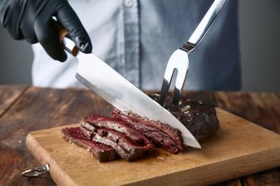 Medium Rare Cooked Whale Meat Steak Sliced with Knife and Fork – Free Download