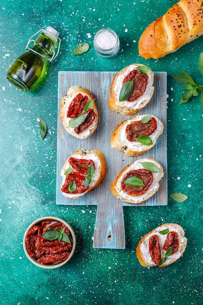 Bruschetta with Cheese, Dry Tomatoes, and Basil – Free Stock Photo for Download