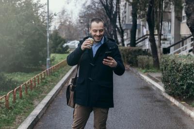 Man Using Smartphone on Street – Free Download