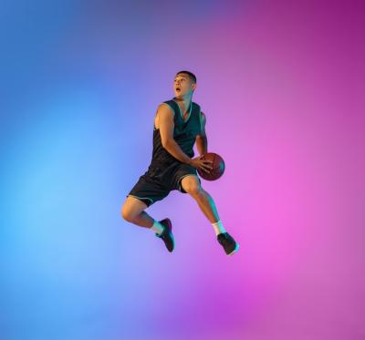 Dynamic Young Basketball Player in Motion Against a Neon Gradient Background – Free Download