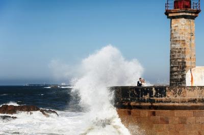 Couple gazing at the ocean near a lighthouse – Free Stock Photo, Download Free