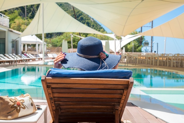 Woman Relaxing by the Pool on a Deck Chair – Free Stock Photo, Download for Free