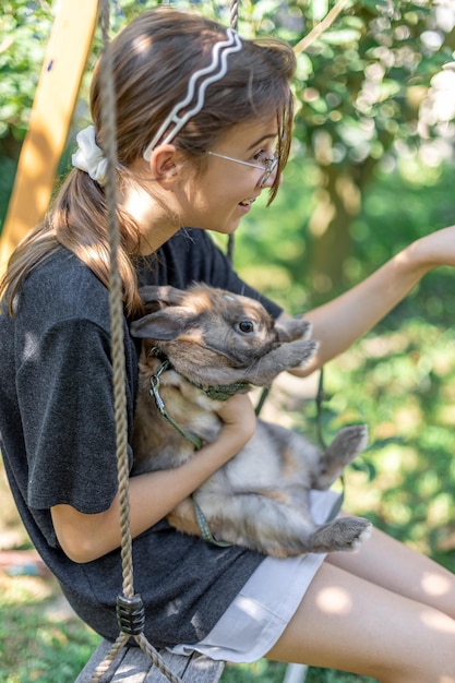 A Girl Playing with a Domestic Rabbit: Pet Concept – Free Download