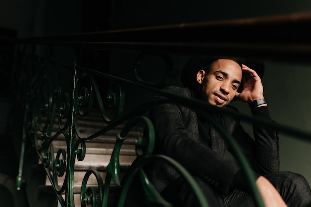 Inspired African Man Relaxing on Stairs – Free Stock Photo for Download